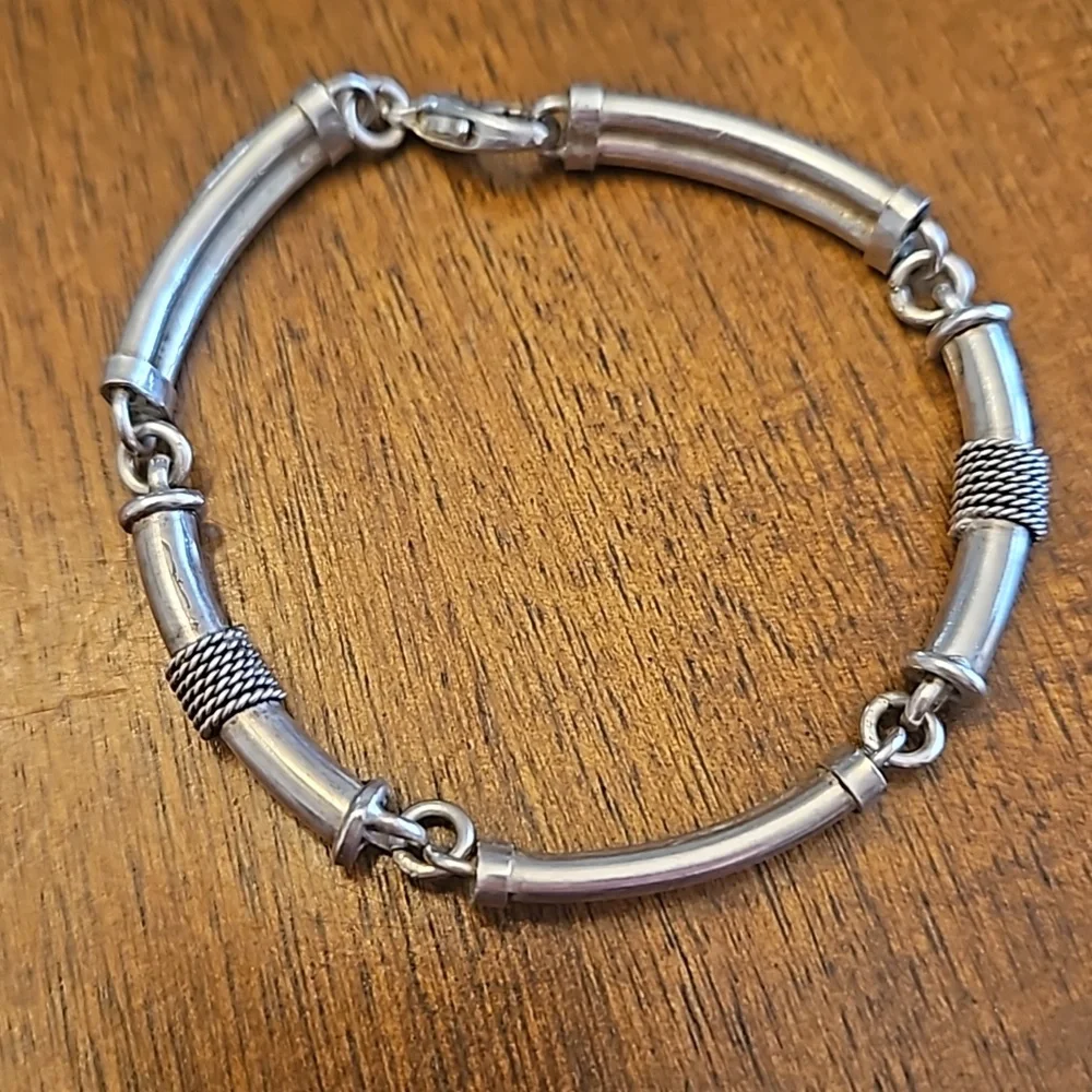Three silver-toned bracelets - at least one is sterling silver - Picture 3 of 5